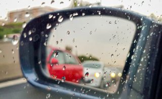car side mirror with rain drops