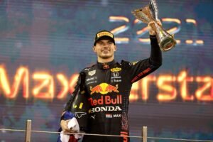 F1 World Drivers Champion MaxVerstappen of Netherlands and Red Bull Racing celebrates on the podium during the F1 Grand Prix of Abu Dhabi at Yas Marina Circuit on December 12, 2021 